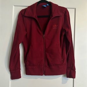 Adidas women’s small zip up maroon jacket.